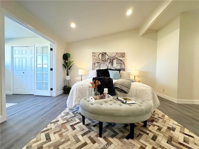 bedroom featuring recessed lighting, vaulted ceiling, baseboards, and wood finished floors