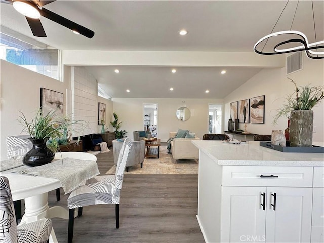 dining area with recessed lighting, visible vents, vaulted ceiling with beams, and wood finished floors