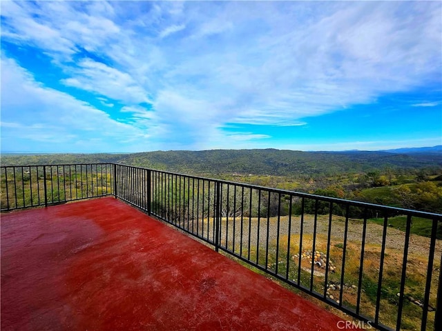 balcony with a mountain view and a view of trees