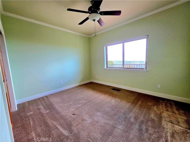 spare room featuring visible vents, baseboards, ceiling fan, dark colored carpet, and crown molding