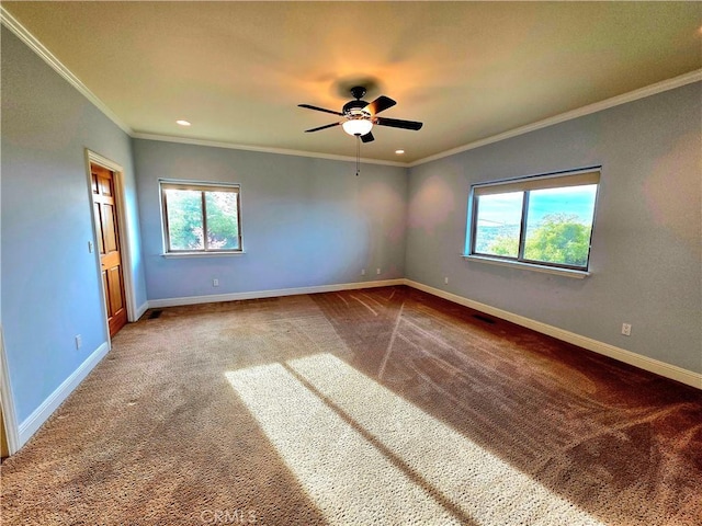 unfurnished room with carpet floors, a healthy amount of sunlight, and baseboards