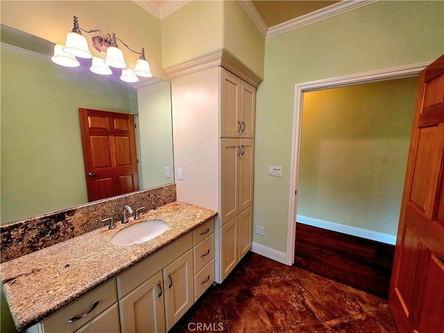 bathroom featuring baseboards, crown molding, and vanity