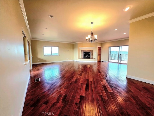 unfurnished living room with a fireplace with raised hearth, crown molding, baseboards, and wood finished floors