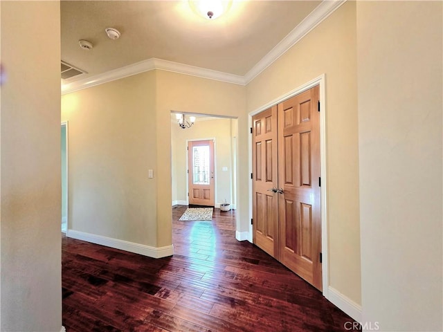 foyer with visible vents, baseboards, dark wood-style flooring, and crown molding