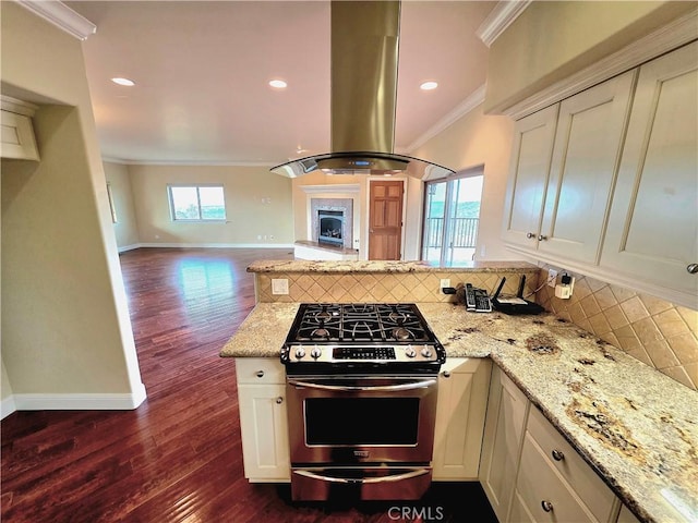 kitchen featuring crown molding, island exhaust hood, open floor plan, stainless steel range with gas stovetop, and a peninsula