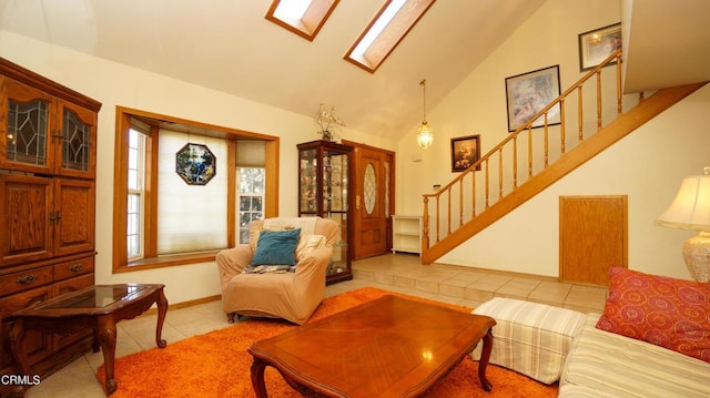 tiled living room featuring high vaulted ceiling, a skylight, stairway, and baseboards