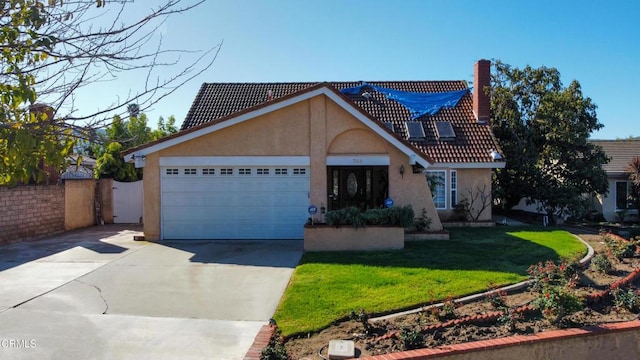 view of front of home with concrete driveway, a front yard, an attached garage, and stucco siding