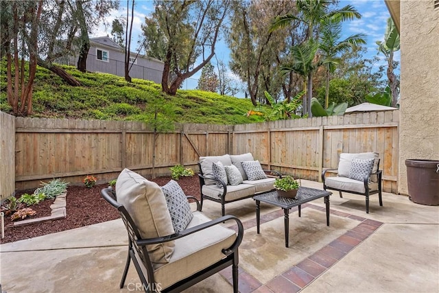 view of patio featuring a fenced backyard and an outdoor living space