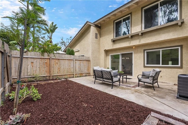 exterior space with a patio area, a fenced backyard, an outdoor hangout area, and central AC