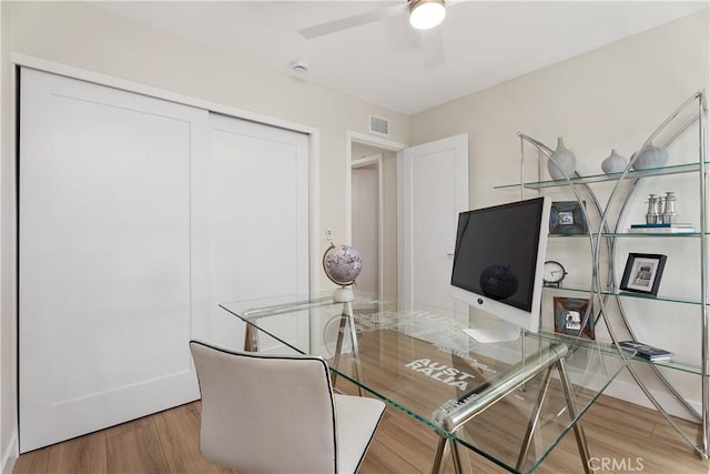 office area featuring visible vents, wood finished floors, and a ceiling fan