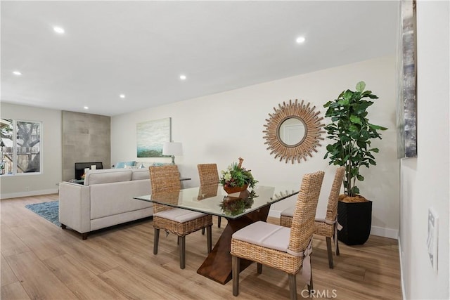 dining space with light wood-type flooring and recessed lighting