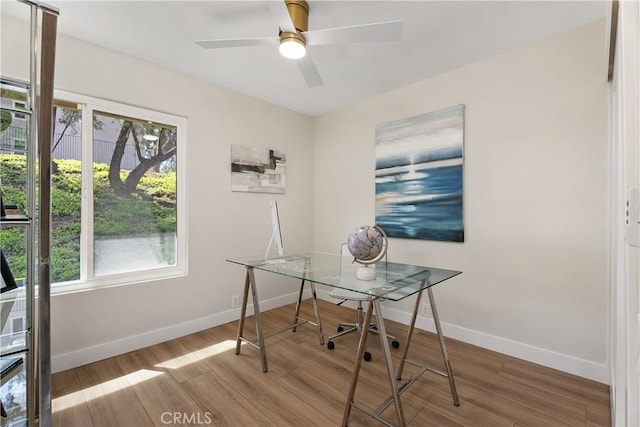 office with ceiling fan, baseboards, and wood finished floors