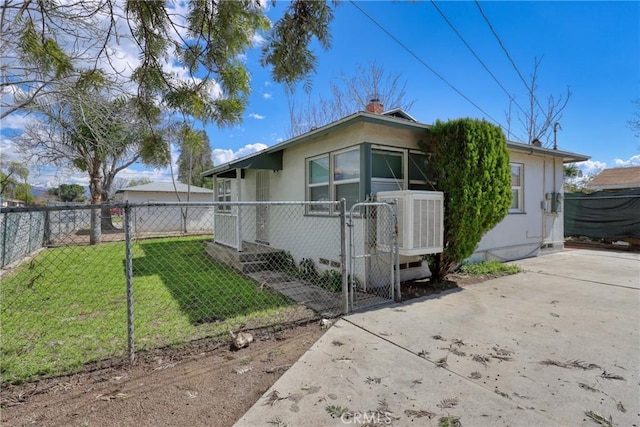 view of front of property with a fenced front yard, crawl space, a front lawn, and a gate