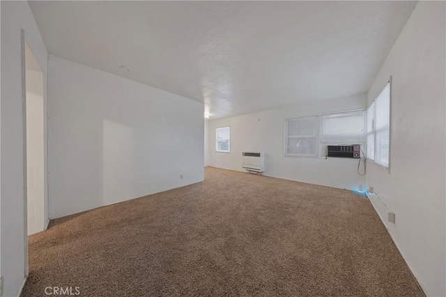 unfurnished living room featuring carpet floors, cooling unit, and heating unit