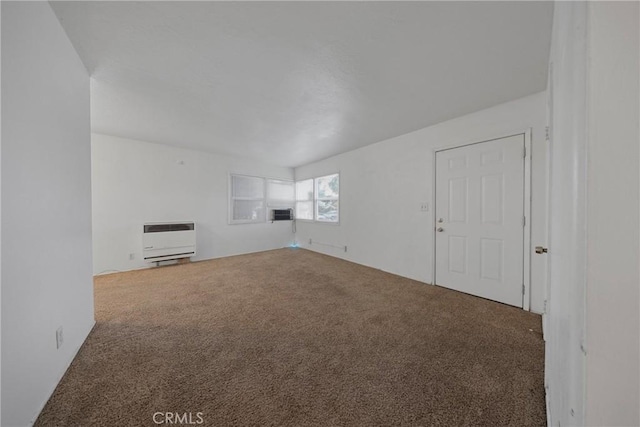 unfurnished living room featuring carpet floors and heating unit