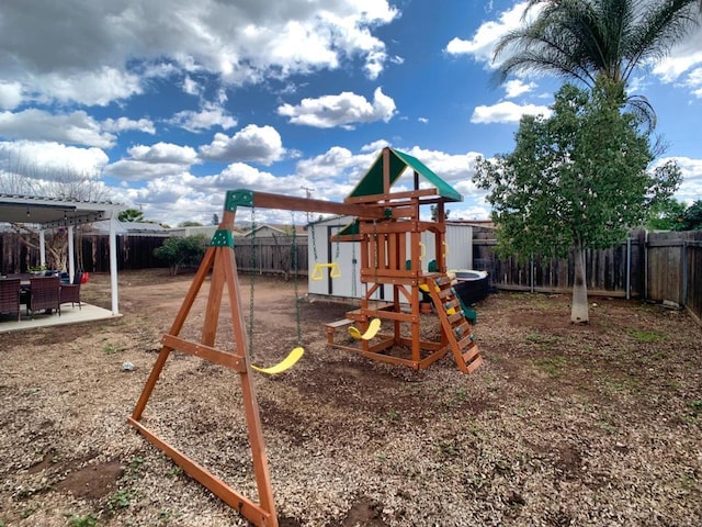 view of play area featuring a fenced backyard and a patio