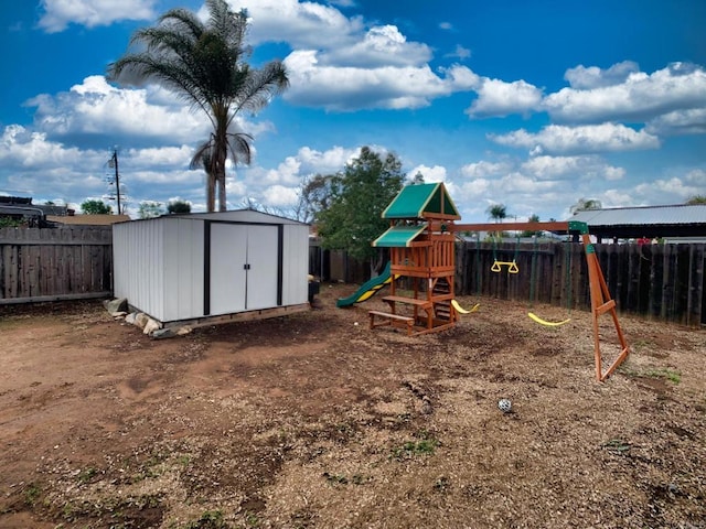 view of play area featuring a fenced backyard, an outdoor structure, and a storage unit