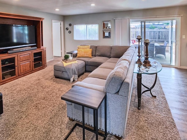 living room featuring baseboards, plenty of natural light, wood finished floors, and recessed lighting