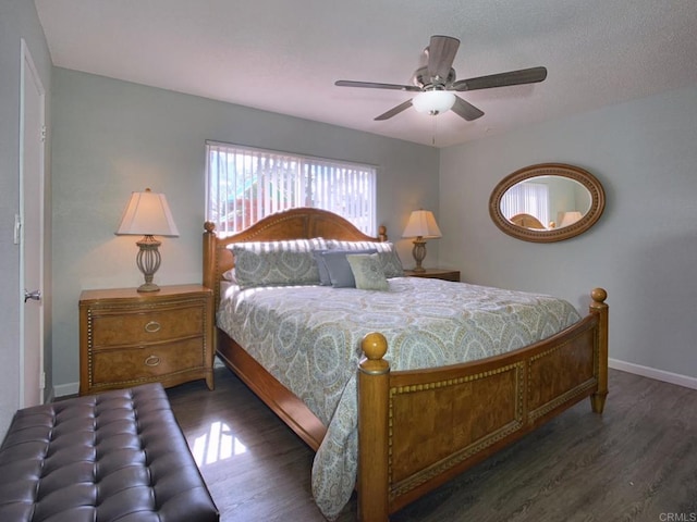 bedroom featuring a ceiling fan, baseboards, and wood finished floors