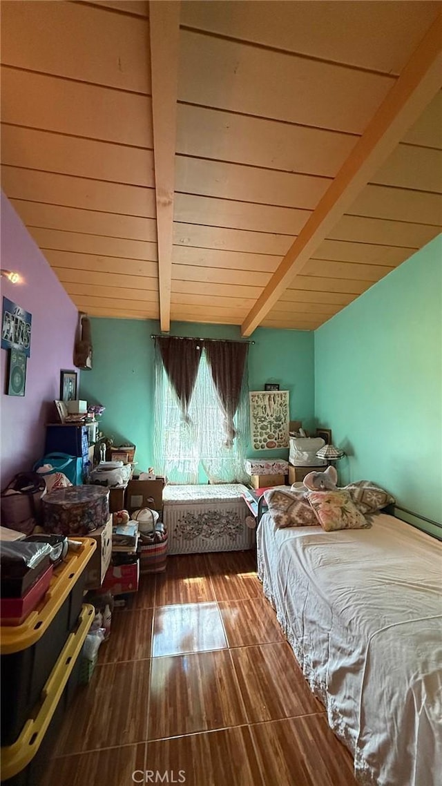 bedroom with vaulted ceiling with beams, wood finished floors, and wood ceiling