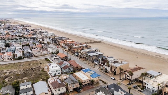 aerial view with a residential view, a water view, and a view of the beach