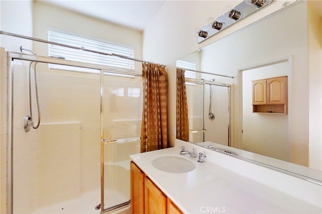 full bath featuring a stall shower and vanity