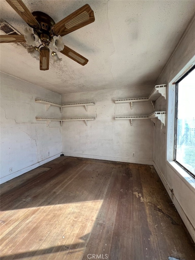 interior space featuring wood-type flooring, visible vents, and a textured ceiling