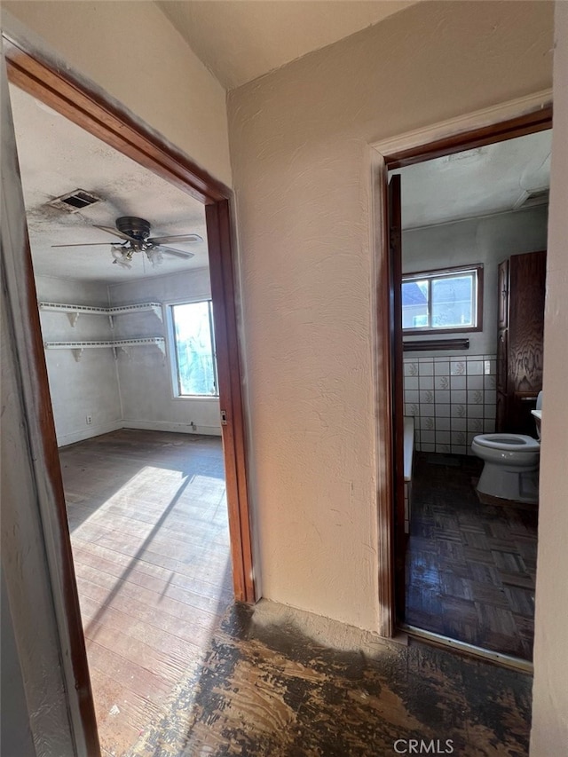 corridor with visible vents and a textured wall