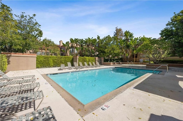 community pool with a patio area