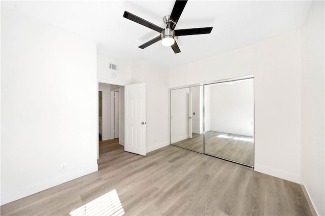 unfurnished bedroom with baseboards, visible vents, and wood finished floors