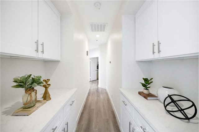 hallway featuring recessed lighting, baseboards, visible vents, and light wood finished floors