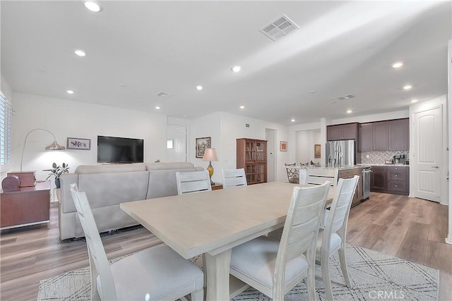 dining space featuring recessed lighting, visible vents, and light wood-type flooring