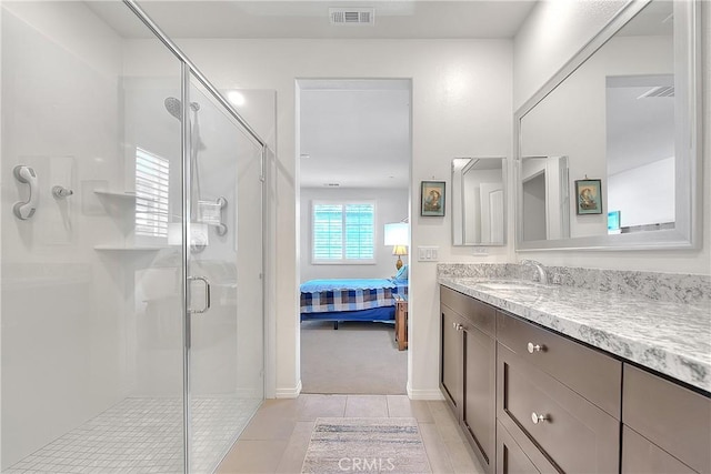 full bathroom with vanity, a shower stall, visible vents, and connected bathroom