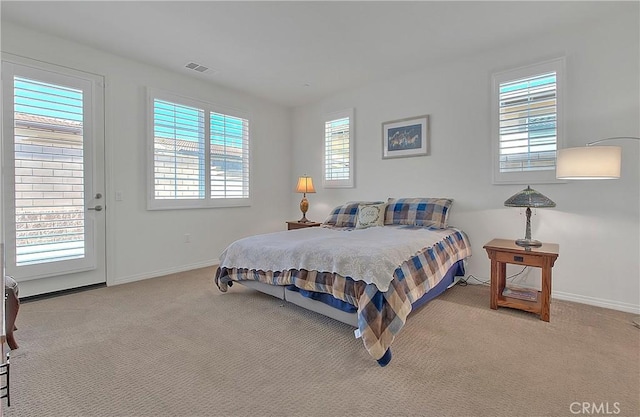 carpeted bedroom with visible vents and baseboards