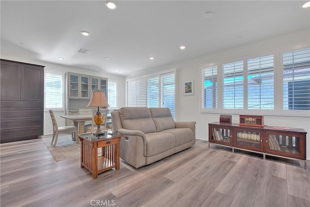 living area featuring recessed lighting, visible vents, and light wood-style flooring