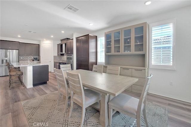 dining area with recessed lighting, visible vents, light wood finished floors, and baseboards