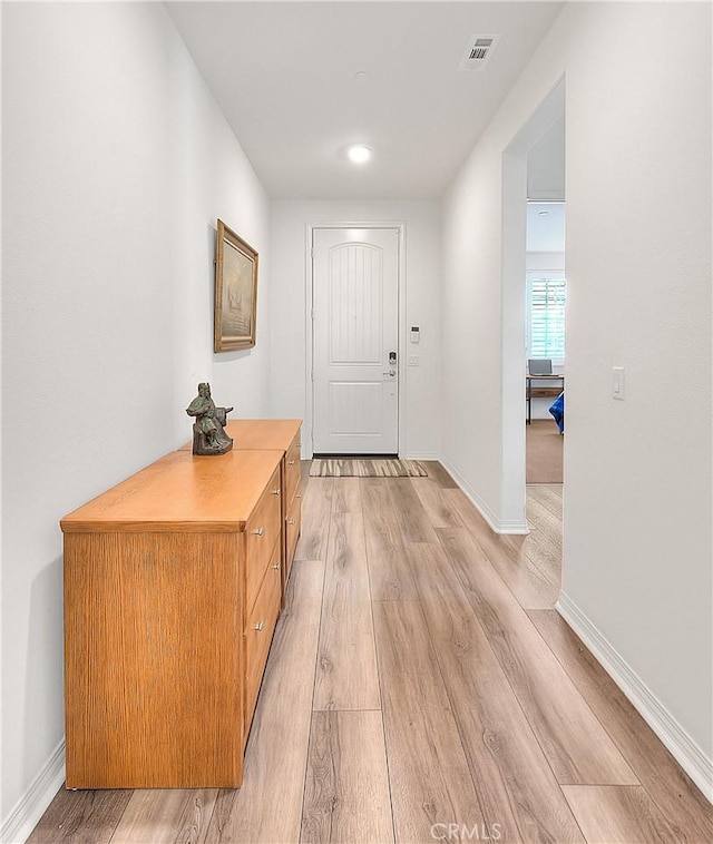 entrance foyer featuring light wood-type flooring, visible vents, and baseboards