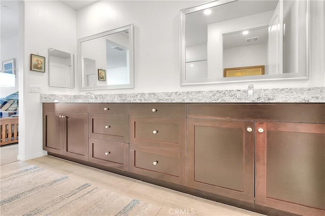 full bath with tile patterned floors, a sink, and double vanity