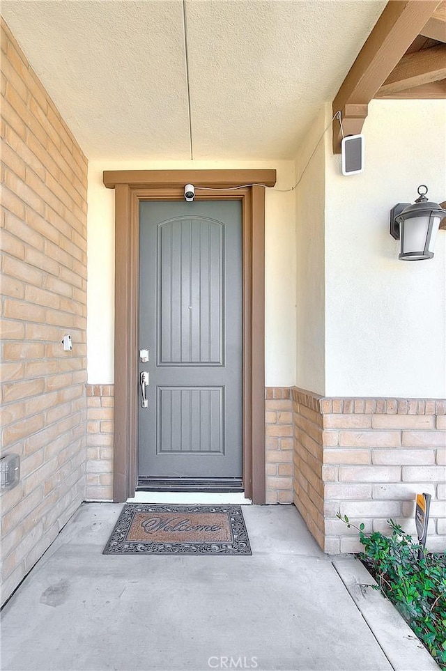 property entrance featuring brick siding