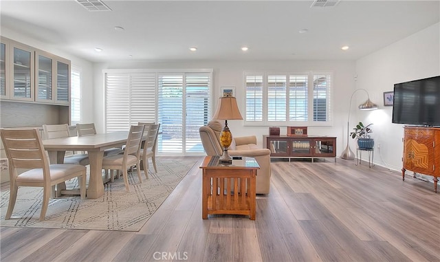 living room with recessed lighting, plenty of natural light, and wood finished floors