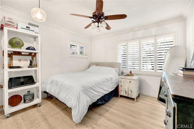 bedroom featuring light wood finished floors, baseboards, ornamental molding, and ceiling fan