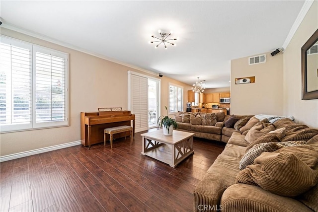 living area featuring a notable chandelier, dark wood-style flooring, visible vents, baseboards, and ornamental molding