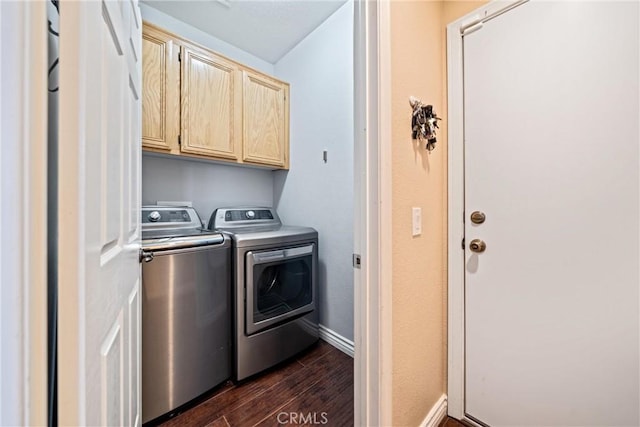 laundry room with dark wood-style floors, independent washer and dryer, cabinet space, and baseboards