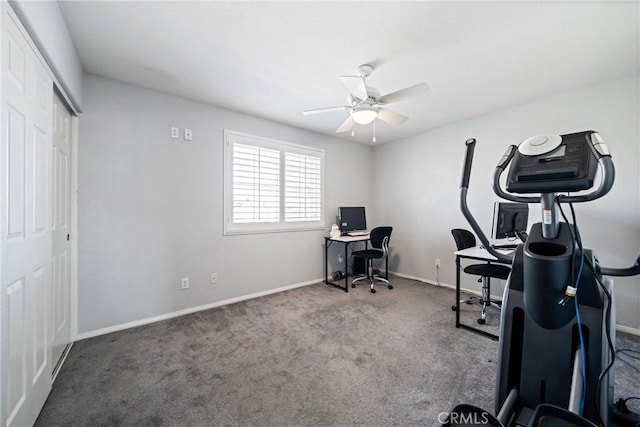 carpeted office space with baseboards and a ceiling fan