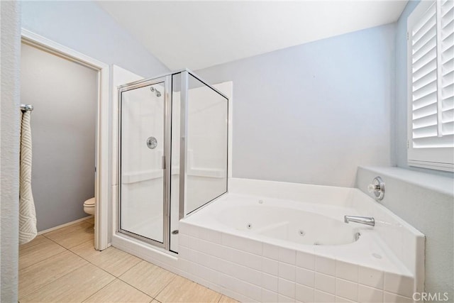 full bath with a stall shower, tile patterned flooring, a jetted tub, and toilet