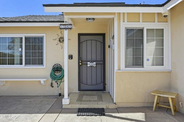 doorway to property with stucco siding