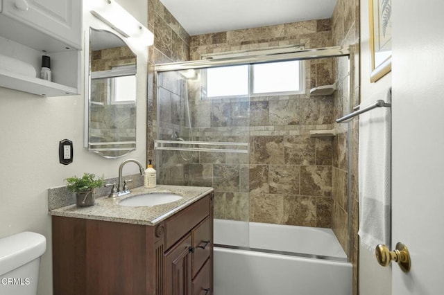 bathroom with vanity, toilet, and enclosed tub / shower combo