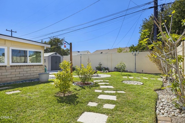 view of yard featuring an outbuilding, a storage shed, and a fenced backyard