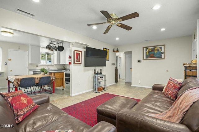 living room with light tile patterned floors, a ceiling fan, visible vents, baseboards, and recessed lighting