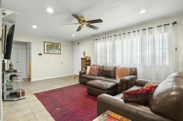 living area with recessed lighting, baseboards, light tile patterned flooring, and a ceiling fan